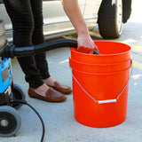 Mytee 8070 A110 drain hose emptying the recovery tank into a bucket